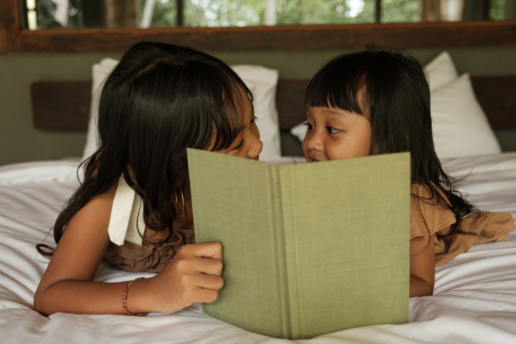 Family Vacation Sisters Reading in Bed
